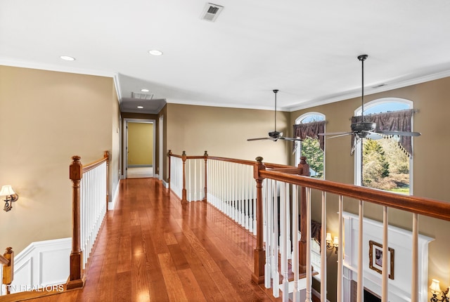 corridor featuring hardwood / wood-style flooring and crown molding