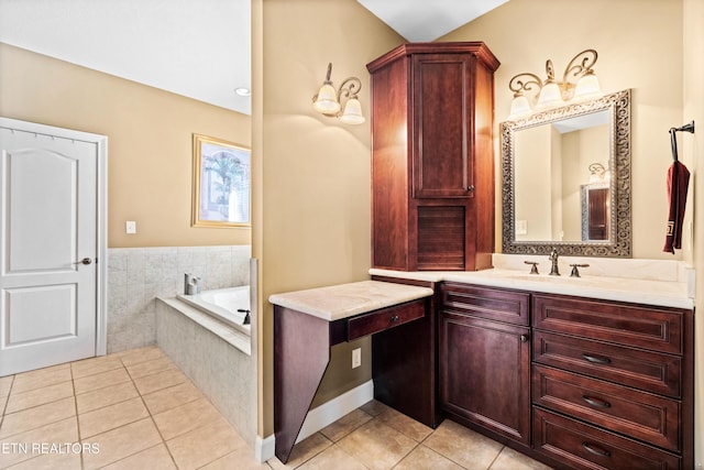 bathroom featuring tile patterned flooring, vanity, and a relaxing tiled tub