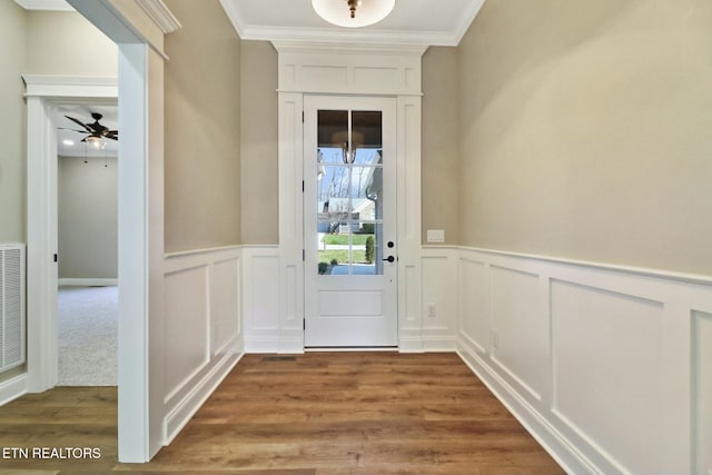 doorway to outside featuring hardwood / wood-style flooring and ornamental molding