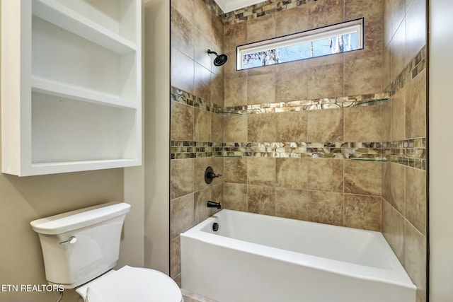 bathroom with toilet and tiled shower / bath combo