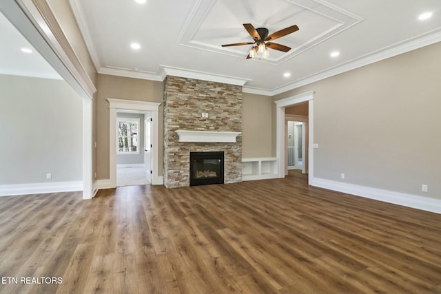 unfurnished living room featuring ornamental molding, ceiling fan, and a fireplace