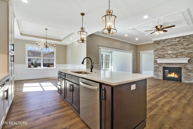 kitchen with an island with sink, sink, stainless steel dishwasher, a raised ceiling, and dark brown cabinets