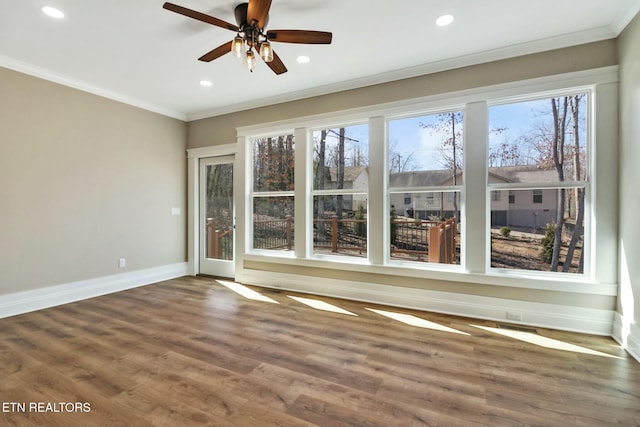 unfurnished room with ornamental molding, hardwood / wood-style floors, and ceiling fan