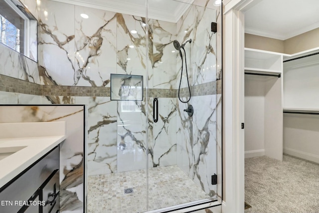 bathroom featuring vanity, crown molding, and a shower with door