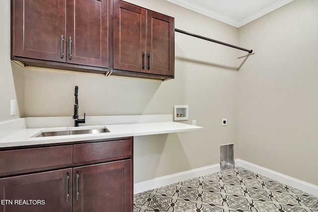 laundry room with sink, cabinets, ornamental molding, hookup for a washing machine, and hookup for an electric dryer