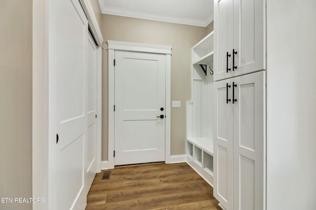 mudroom with hardwood / wood-style floors and crown molding