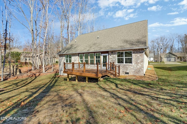 back of property with a deck and a lawn