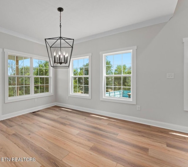 1094 W Glenview Dr, Lenoir City, TN 37771 - unfurnished dining area with baseboards, crown molding, a chandelier, and light wood-type flooring