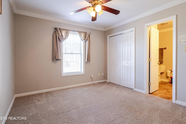 unfurnished bedroom featuring crown molding, light carpet, ceiling fan, and a closet