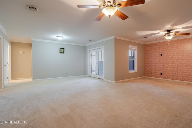 unfurnished room featuring crown molding, light colored carpet, and ceiling fan