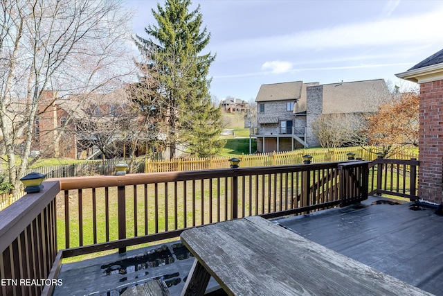 wooden terrace with a lawn