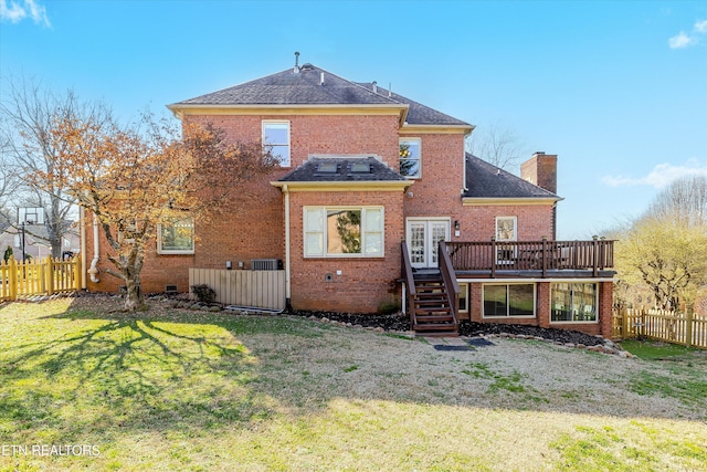 back of property with a wooden deck and a lawn