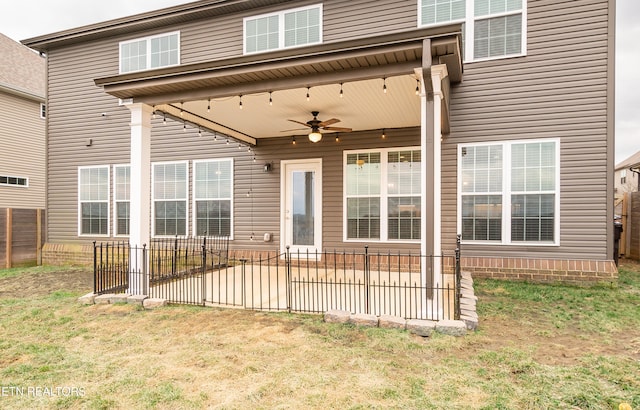 back of house with a yard, ceiling fan, and a patio area