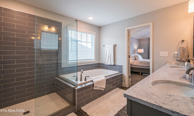 bathroom with vanity and independent shower and bath