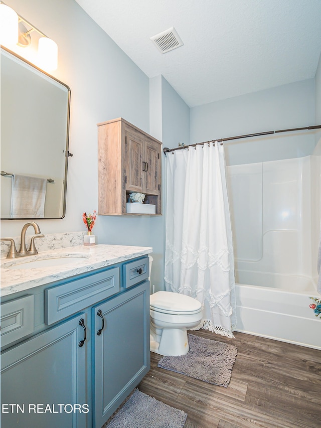 full bathroom featuring toilet, vanity, shower / bathtub combination with curtain, and hardwood / wood-style floors