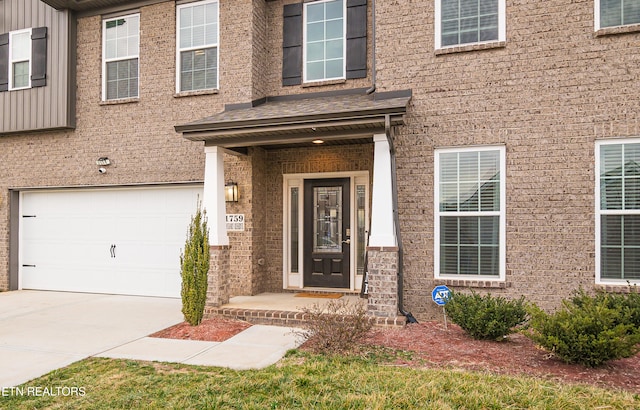 view of exterior entry with a garage