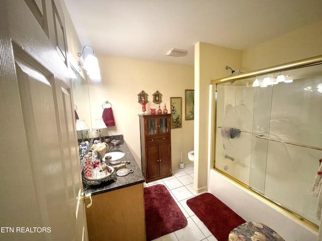 5001 Cheyenne Dr, Crossville, TN 38572 - bathroom featuring vanity, tile patterned floors, toilet, and bath / shower combo with glass door