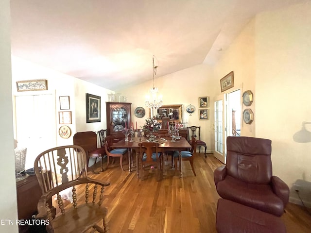 5001 Cheyenne Dr, Crossville, TN 38572 - dining area with vaulted ceiling, wood finished floors, a chandelier, and plenty of natural light