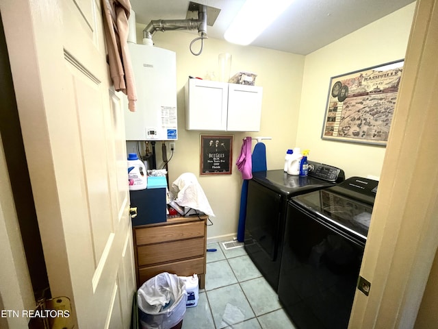 5001 Cheyenne Dr, Crossville, TN 38572 - laundry room with tankless water heater, washing machine and dryer, light tile patterned floors, and cabinet space