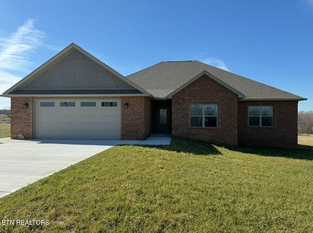 view of front of property with a garage and a front lawn