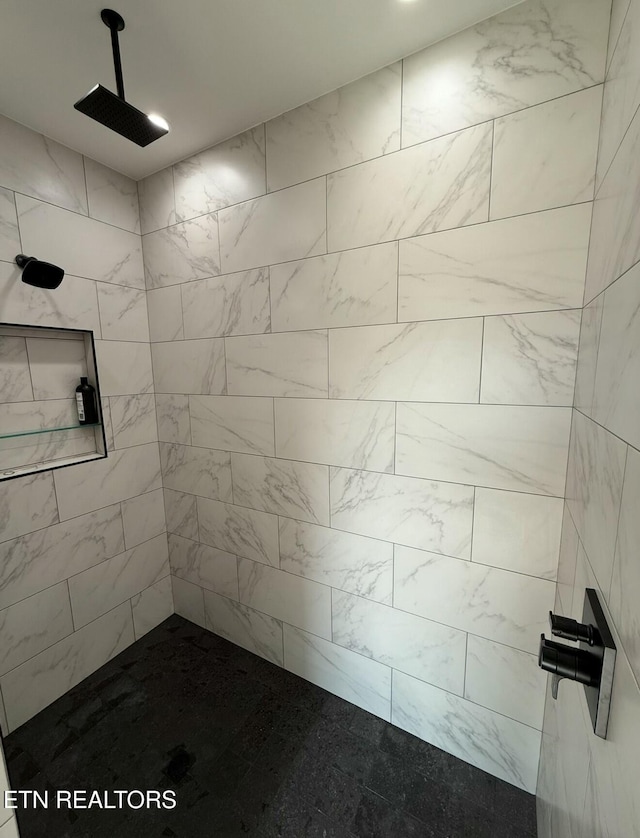 bathroom with tiled shower