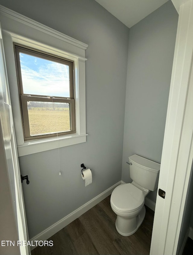 bathroom with hardwood / wood-style flooring and toilet