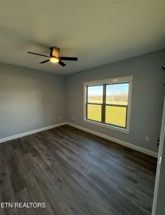 empty room featuring ceiling fan and dark hardwood / wood-style floors