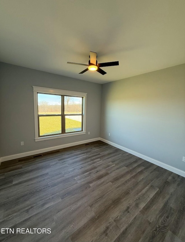 spare room featuring dark hardwood / wood-style floors and ceiling fan