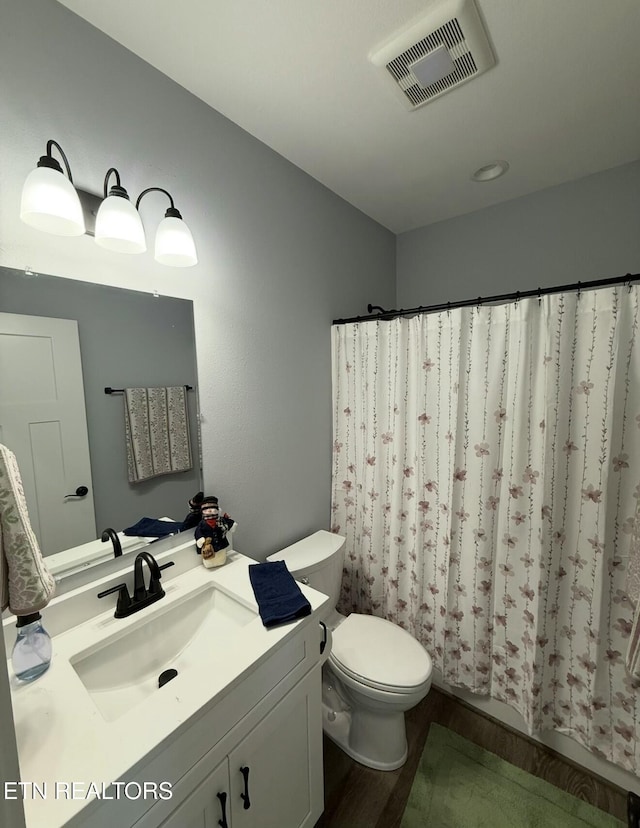 bathroom featuring hardwood / wood-style flooring, vanity, and toilet