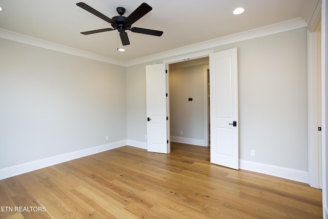 unfurnished bedroom with light hardwood / wood-style flooring, ornamental molding, and ceiling fan