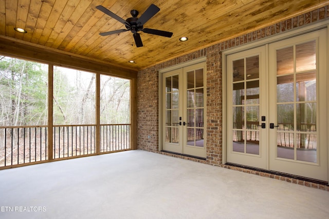 unfurnished sunroom with wooden ceiling, french doors, and a healthy amount of sunlight