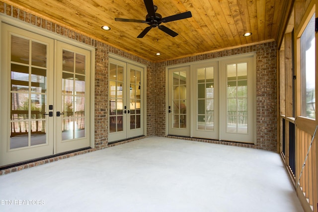 unfurnished sunroom with wood ceiling and french doors