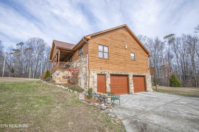 view of side of home with a garage and a yard