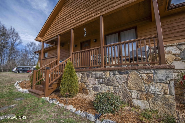 view of exterior entry featuring a porch