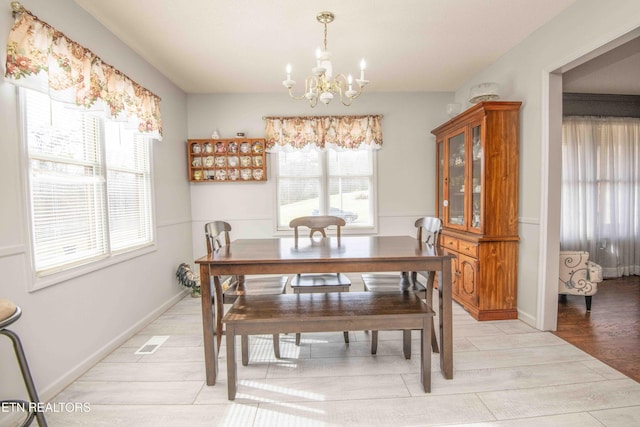 dining room featuring a chandelier and light hardwood / wood-style flooring