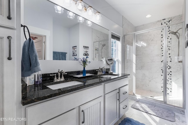 bathroom featuring an enclosed shower and vanity