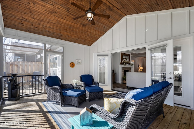 wooden terrace featuring an outdoor living space and ceiling fan