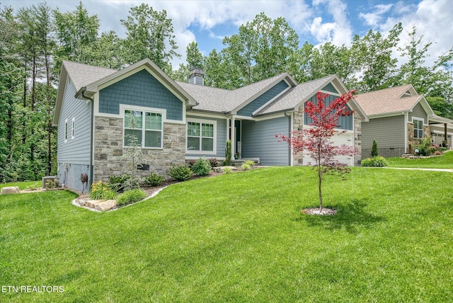 197 Cappshire Rd, Crossville, TN 38558 - craftsman-style house with a chimney, a front yard, stone siding, and roof with shingles