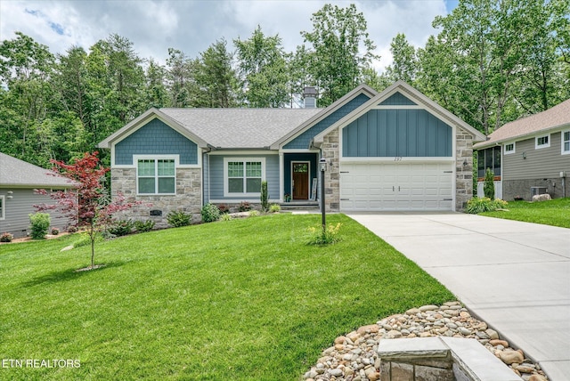 197 Cappshire Rd, Crossville, TN 38558 - view of front of property with stone siding, an attached garage, concrete driveway, board and batten siding, and a front yard