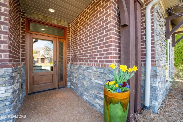 property entrance featuring brick siding