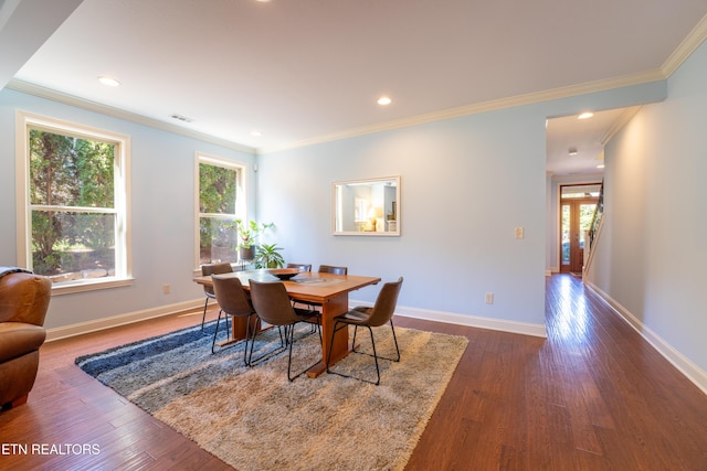 dining room with visible vents, baseboards, dark wood-style floors, and crown molding