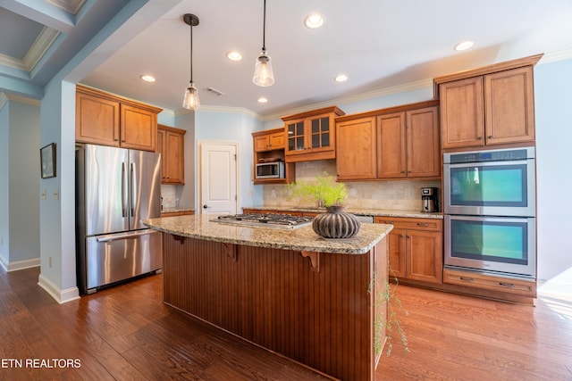 kitchen with stainless steel appliances, dark wood-style floors, brown cabinetry, and crown molding