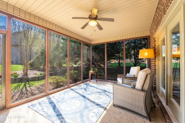 sunroom / solarium with plenty of natural light, ceiling fan, and wooden ceiling