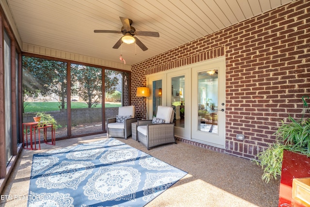 unfurnished sunroom featuring a ceiling fan