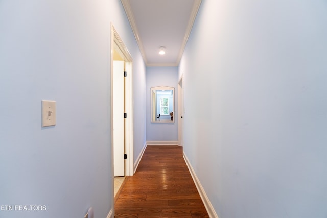 corridor with crown molding, baseboards, and wood finished floors