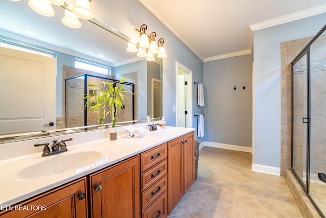 full bathroom with baseboards, double vanity, a stall shower, a sink, and crown molding