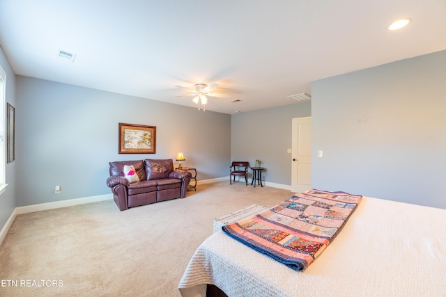 bedroom featuring visible vents, baseboards, and light carpet