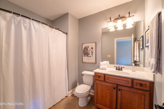 bathroom featuring tile patterned floors, toilet, vanity, and baseboards