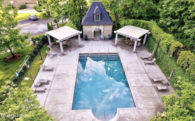 pool featuring a gazebo, a patio area, and fence