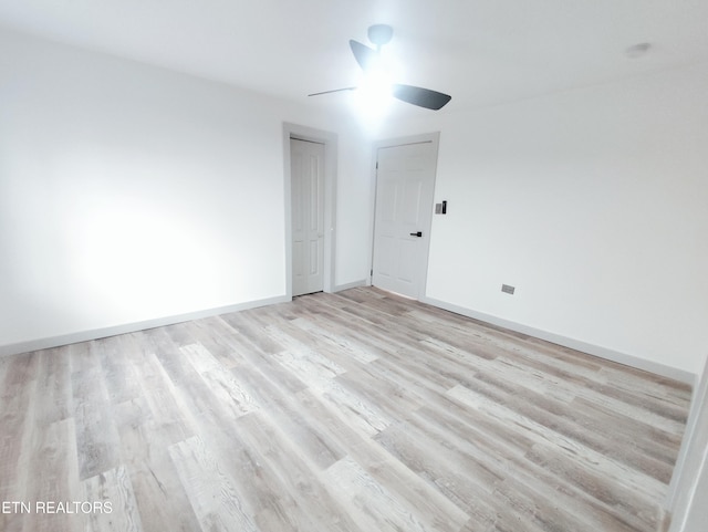 empty room featuring ceiling fan and light wood-type flooring